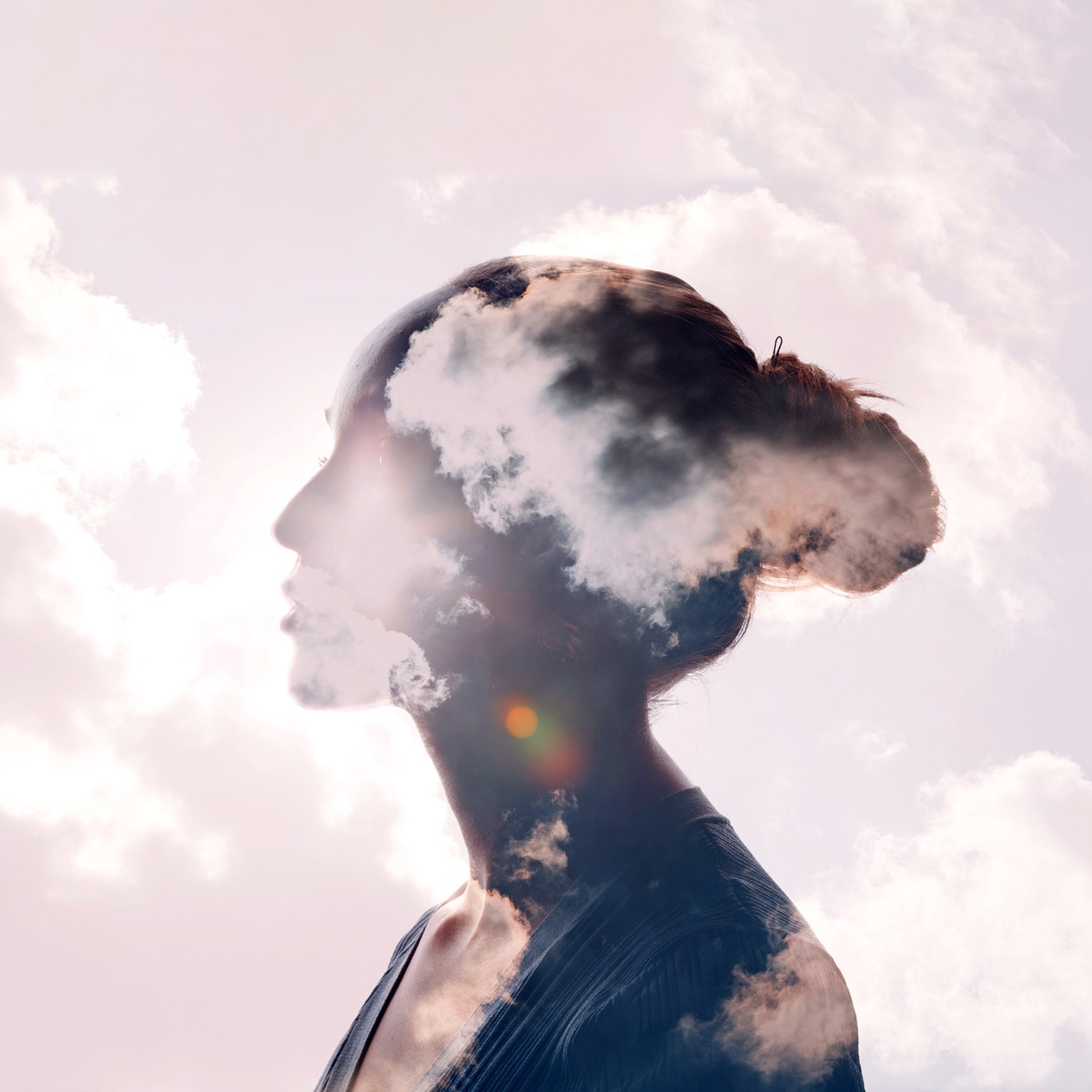 Illustration featuring a silhouette of a woman's head with a sunrise and cloud multiple exposure background.